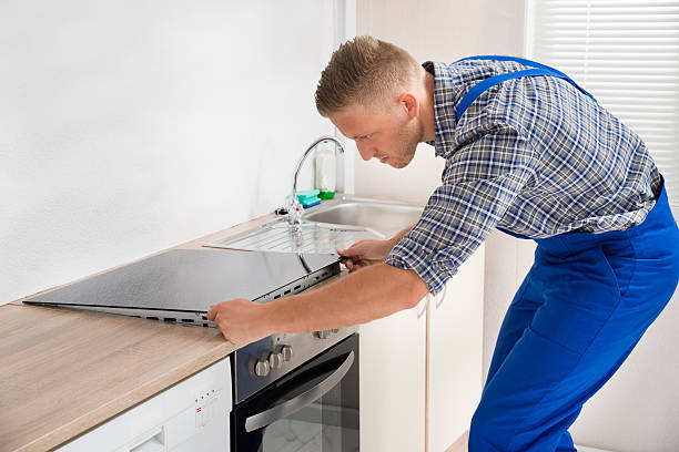 Man installing oven and range